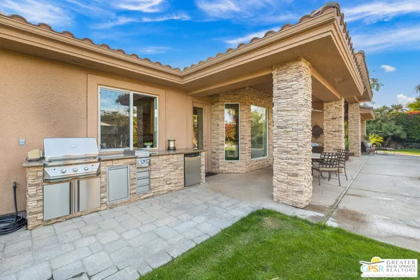 a view of a house with a backyard porch and sitting area