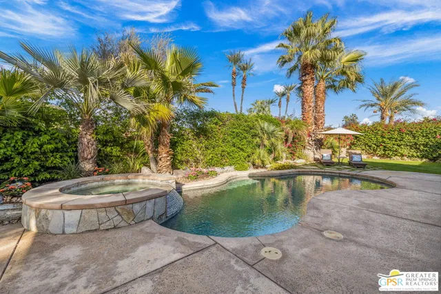 a bedroom with a bed flat screen tv and dresser