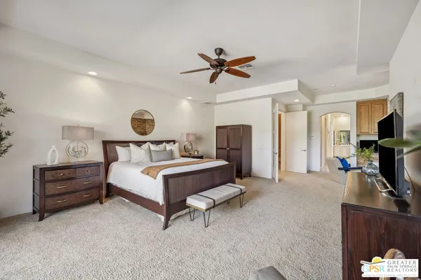 a bedroom with a bed and a ceiling fan