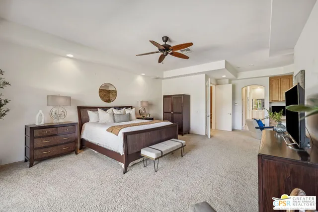 a bedroom with a bed and a ceiling fan