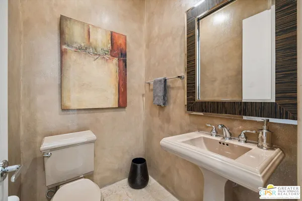 a bedroom with a bed and a potted plant