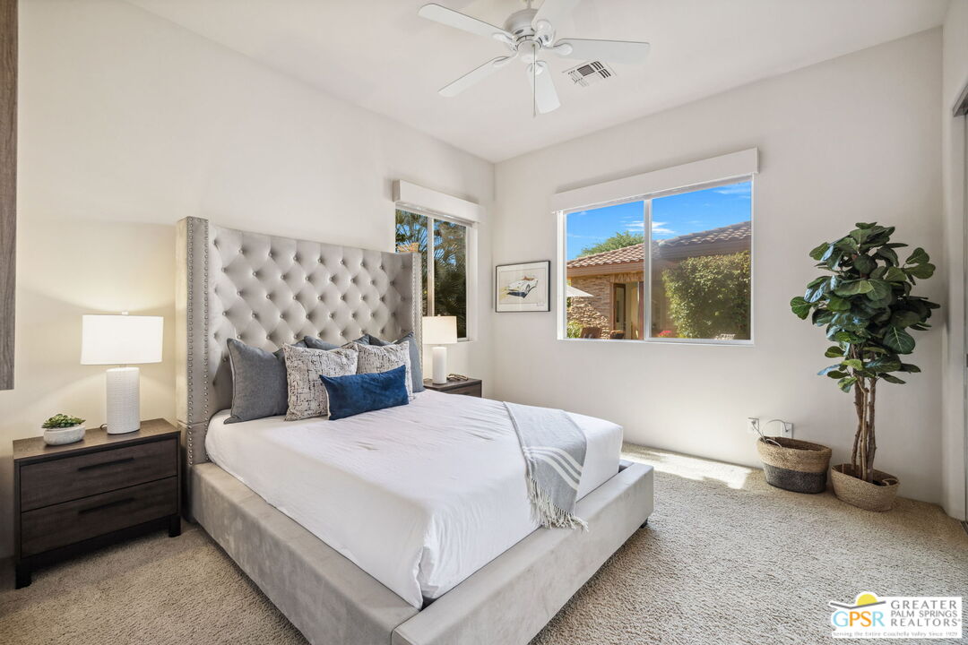 2 Varsity Circle Rancho Mirage, CA 92270 - Photo 49 of 65 a spacious bedroom with a bed and a potted plant