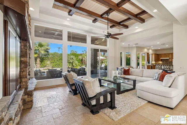 a view of a livingroom and dining room with furniture wooden floor and a chandelier