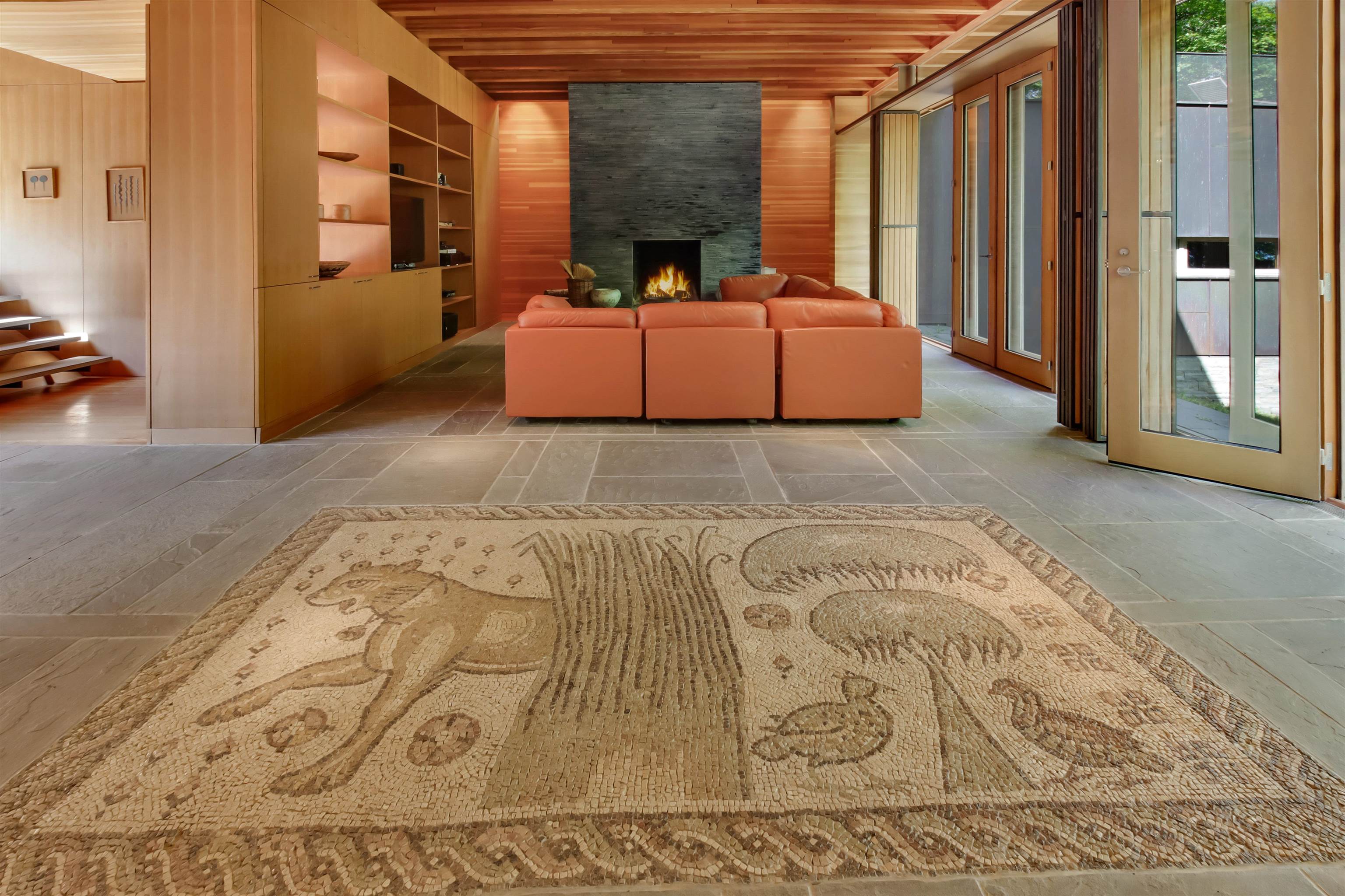 15773 Lake Shore Road Hayward, WI 54843 - Photo 21 of 41 Unfurnished living room with plenty of natural light, wood walls, and a fireplace