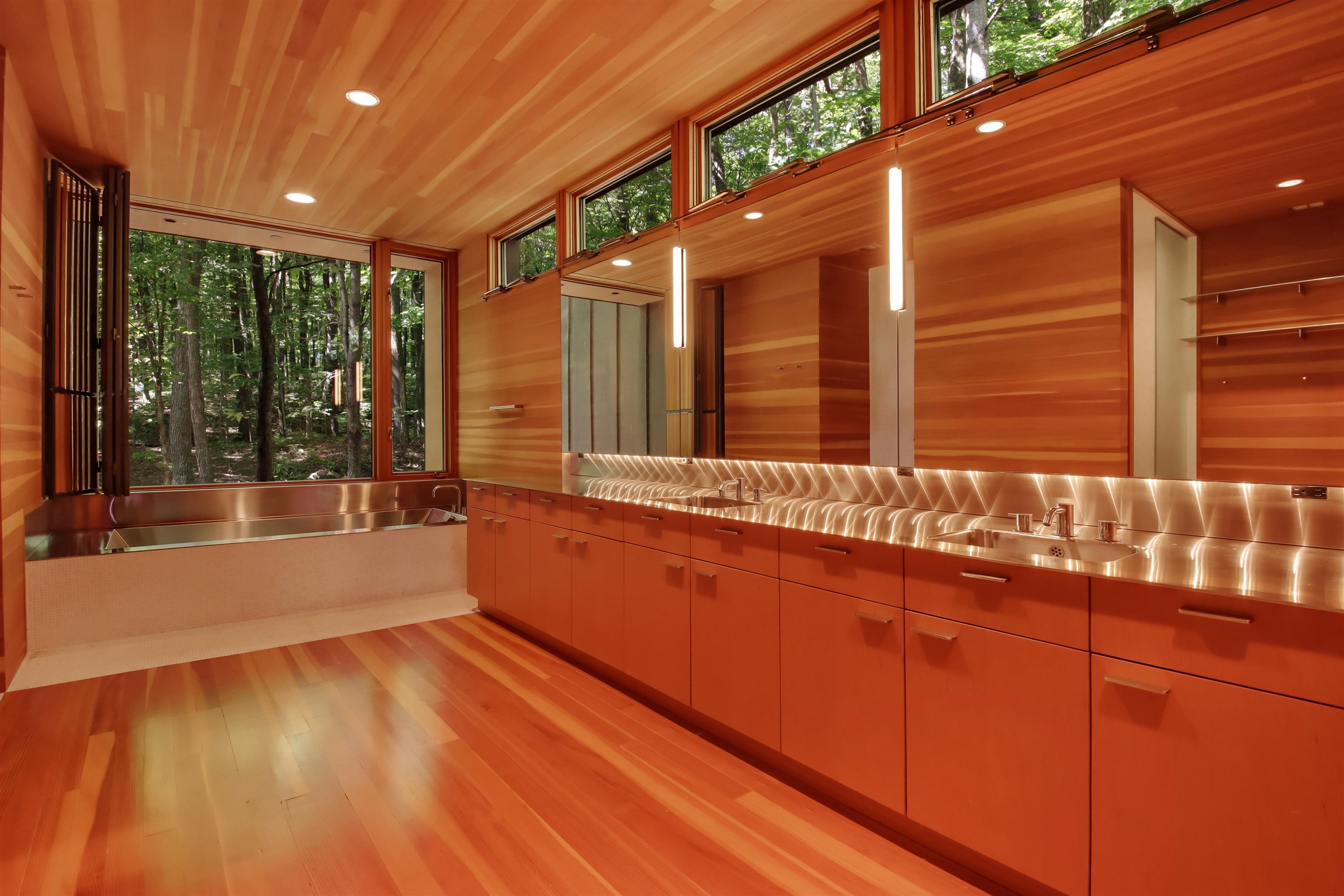 15773 Lake Shore Road Hayward, WI 54843 - Photo 25 of 41 Kitchen with light hardwood / wood-style flooring, wood walls, sink, and stainless steel counters