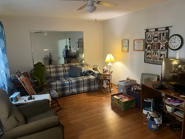 a living room with furniture and wooden floor