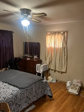 a living room with a bed furniture and a window