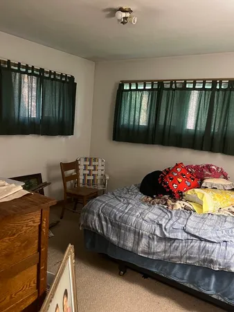 a bedroom with bed and a window