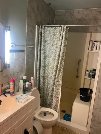 a bathroom with a sink toilet and shower