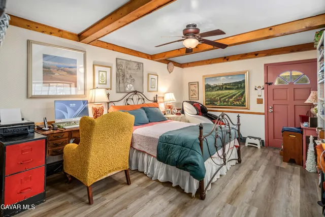 a bedroom with furniture and a window