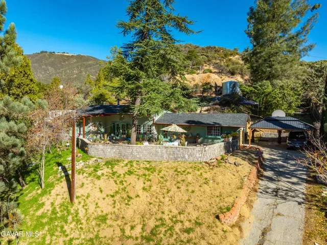 a view of a house with a yard covered with snow in the background