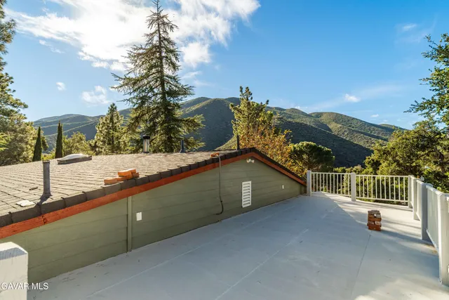 a view of a patio with table and chairs with wooden fence and plants