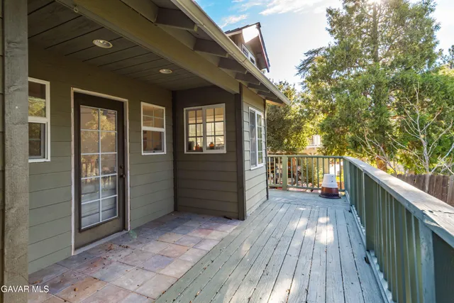 a balcony with wooden floor and fence