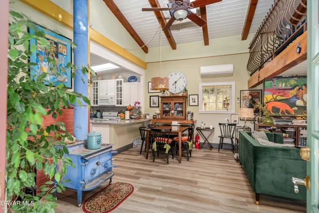 a living room with furniture a dining table with kitchen view