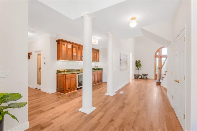 a bathroom with a granite countertop sink a toilet a mirror a vanity and shower