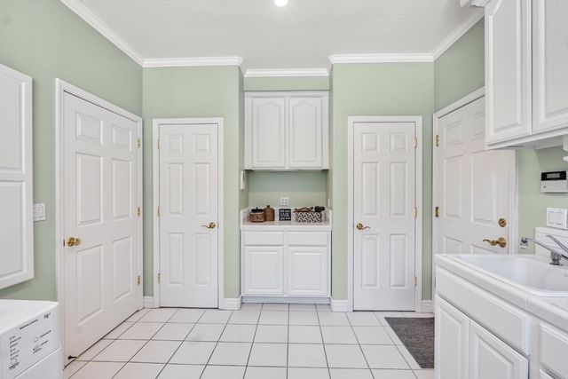 a kitchen with stainless steel appliances kitchen island granite countertop a stove top oven a sink a dining table and chairs with wooden floor