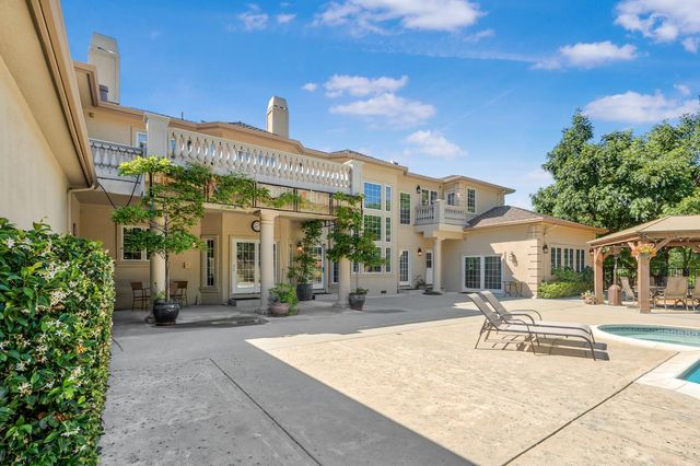 a kitchen with stainless steel appliances granite countertop a refrigerator a sink dishwasher a stove with wooden cabinets and floor