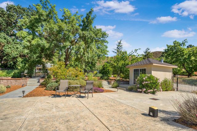 an aerial view of a swimming pool with lawn chairs and plants