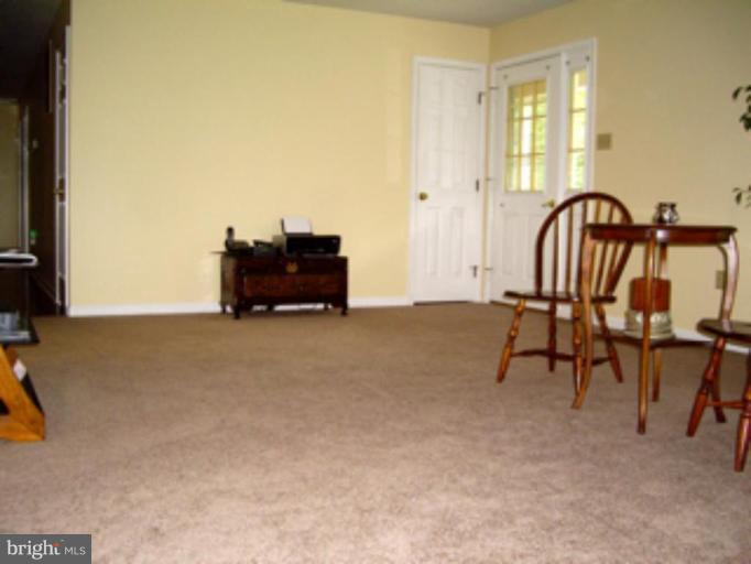 3139 Bayside Road Huntingtown, MD 20639 - Photo 30 of 30 a living room with furniture and a flat screen tv