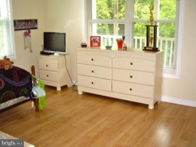 3139 Bayside Road Huntingtown, MD 20639 - Photo 12 of 30 a living room with furniture and a flat screen tv