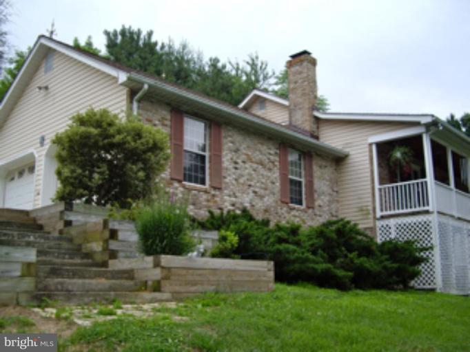 3139 Bayside Road Huntingtown, MD 20639 - Photo 19 of 30 a front view of a house with garden