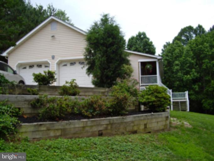 3139 Bayside Road Huntingtown, MD 20639 - Photo 20 of 30 a view of a house with a yard and plants