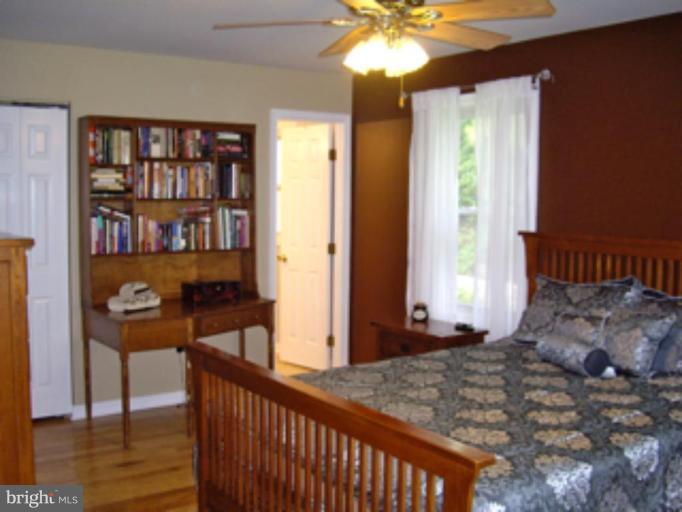 3139 Bayside Road Huntingtown, MD 20639 - Photo 25 of 30 a bedroom with furniture and a window