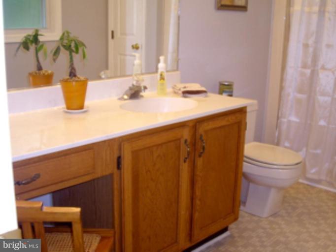 3139 Bayside Road Huntingtown, MD 20639 - Photo 26 of 30 a bathroom with a sink a toilet and mirror