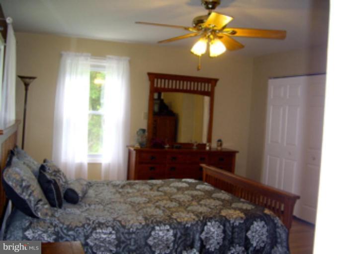 3139 Bayside Road Huntingtown, MD 20639 - Photo 27 of 30 a bedroom with a bed and a dresser