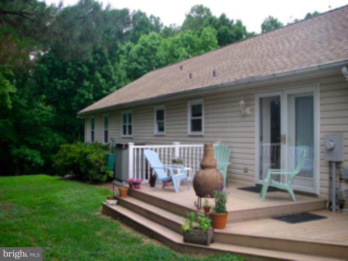 3139 Bayside Road Huntingtown, MD 20639 - Photo 5 of 30 a front view of a house with garden