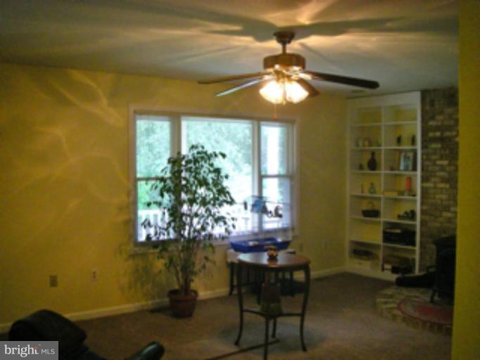 3139 Bayside Road Huntingtown, MD 20639 - Photo 8 of 30 a view of a dining room with furniture and chandelier