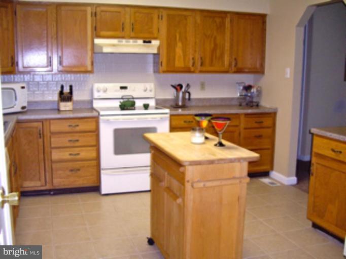 3139 Bayside Road Huntingtown, MD 20639 - Photo 9 of 30 a kitchen with cabinets appliances and a sink