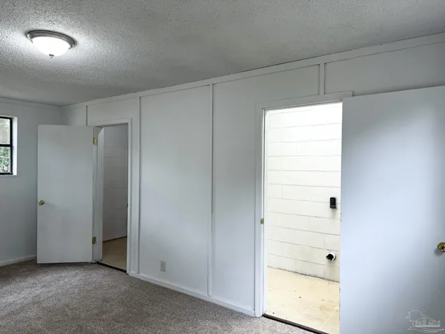 a view of an empty room and a window