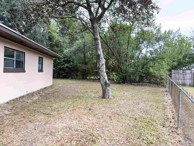 a backyard of a house with lots of green space
