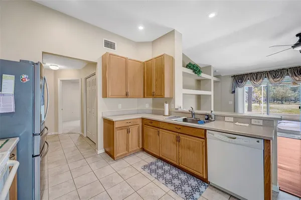 a kitchen with a sink a stove and cabinets