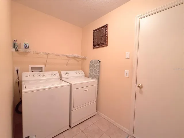 a view of a livingroom with furniture wooden floor and a ceiling fan