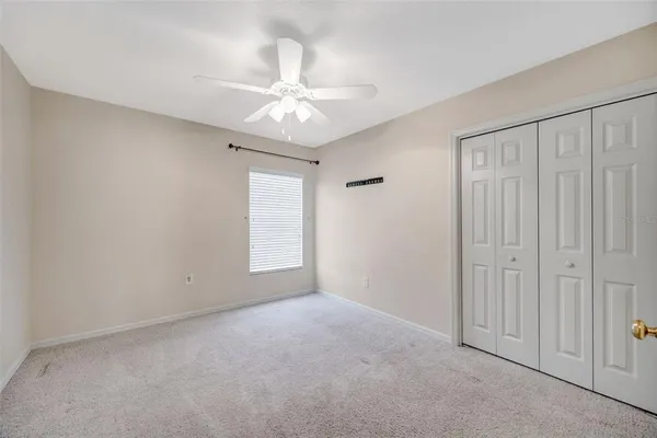 a view of a livingroom with a ceiling fan & wooden floor