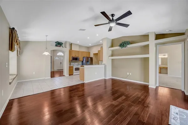 a view of a kitchen with wooden floor and a window