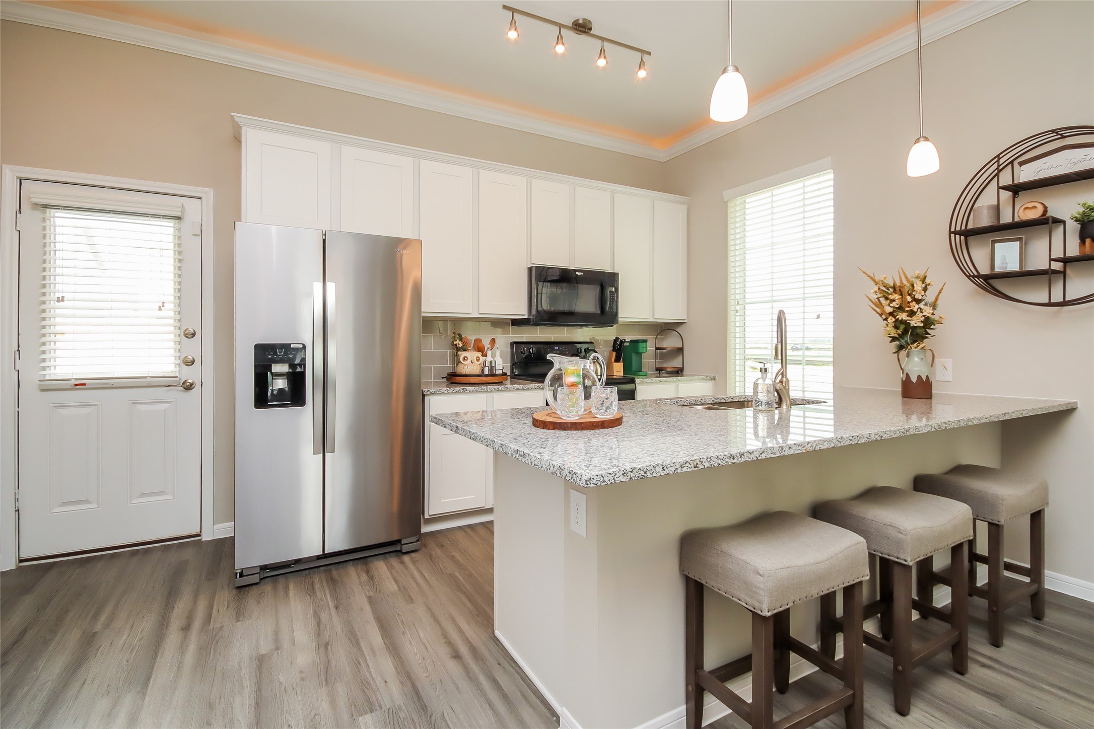 19422 Sparrow Trail Rosharon, TX 77583 - Photo 6 of 24 a kitchen with stainless steel appliances granite countertop a table chairs refrigerator and sink