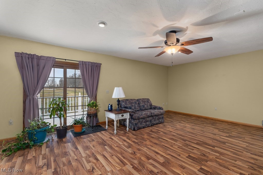 8238 Ruff Road West Salem, OH 44287 - Photo 14 of 27 Sitting room featuring ceiling fan, a textured ceiling, baseboards, and wood finished floors
