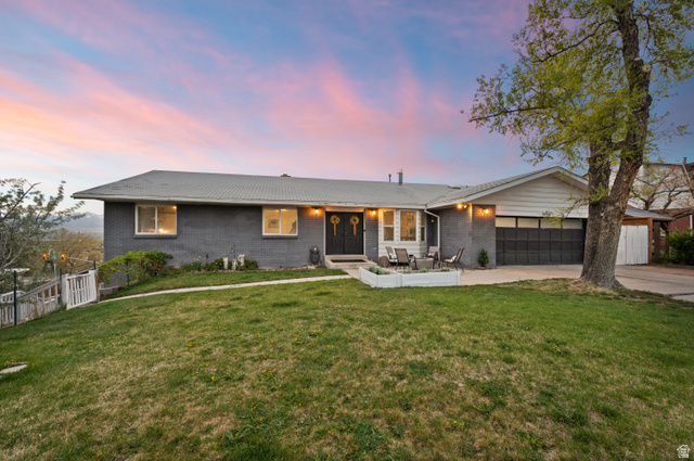 9750 Indian Ridge Drive Sandy, UT 84092 - Photo 4 of 40 Single story home with brick siding, a garage, a yard, and concrete driveway