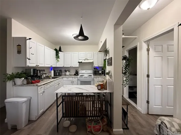 a kitchen with a sink cabinets and window