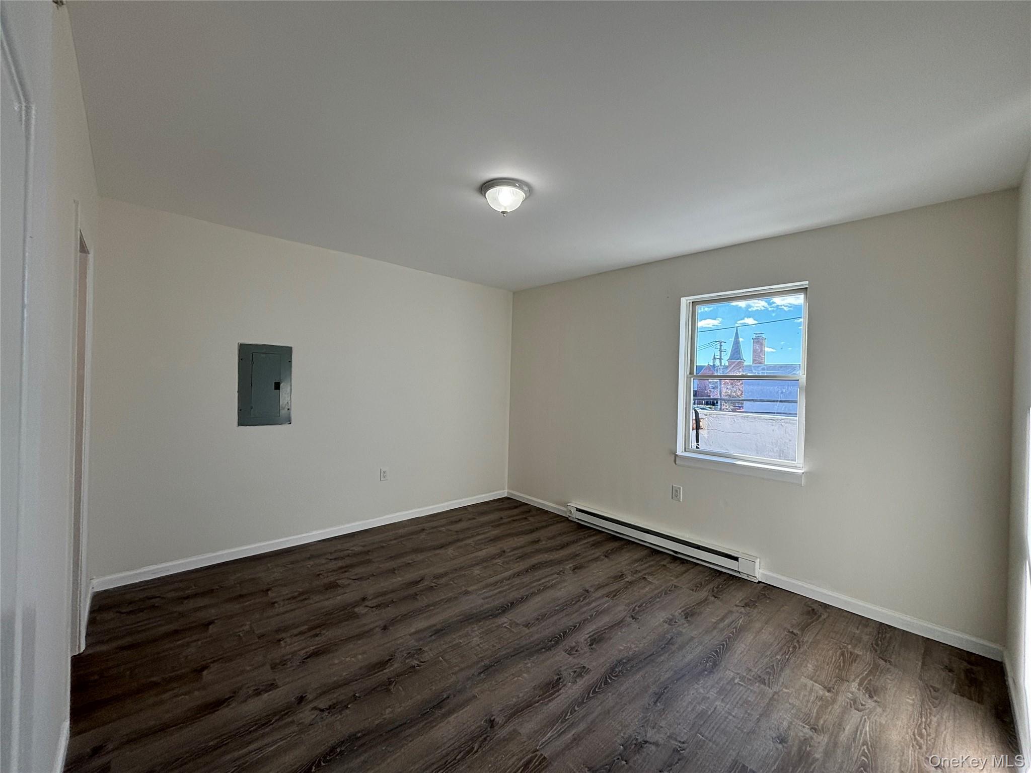 90 East Main Street, Unit 2 Patchogue, NY 11772 - Photo 9 of 14 a view of an empty room with wooden floor and a window