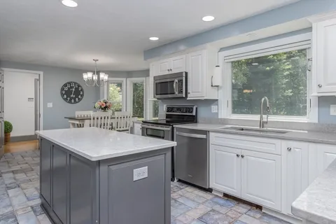 a kitchen with a sink stove and microwave