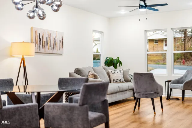 a living room with furniture and wooden floor