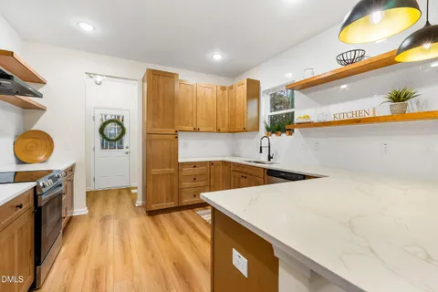 a kitchen with a sink a stove and a refrigerator