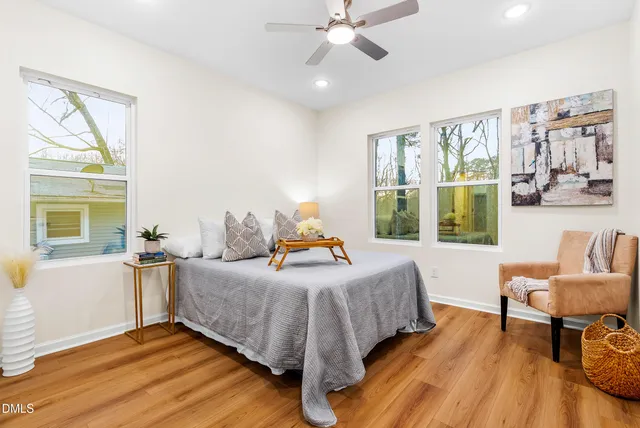 a bedroom with a bed and wooden floor