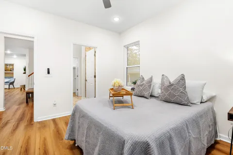 a bedroom with a bed and wooden floor