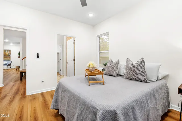 a bedroom with a bed and wooden floor