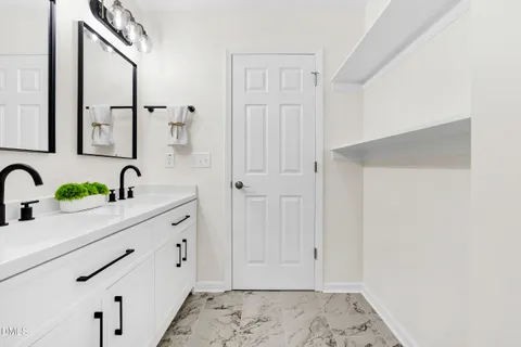a view of bathroom with dual sinks